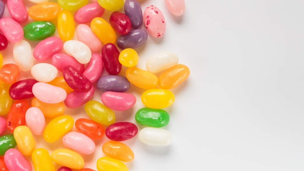 Jelly beans grouped together on a white surface