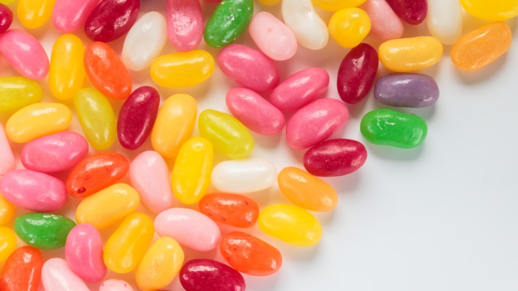 Jelly beans sorted across a white surface