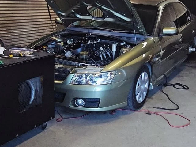A Commodore in the workshop with the bonnet open