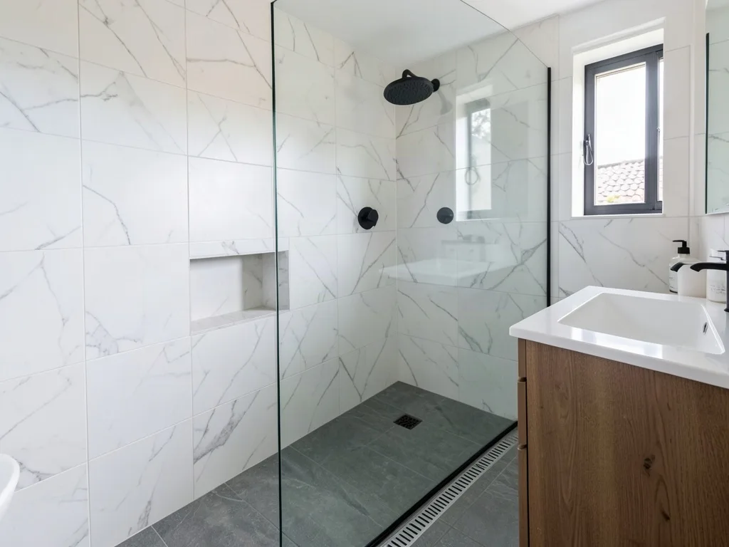 Sample image of a finished bathroom with marble look wall tiles