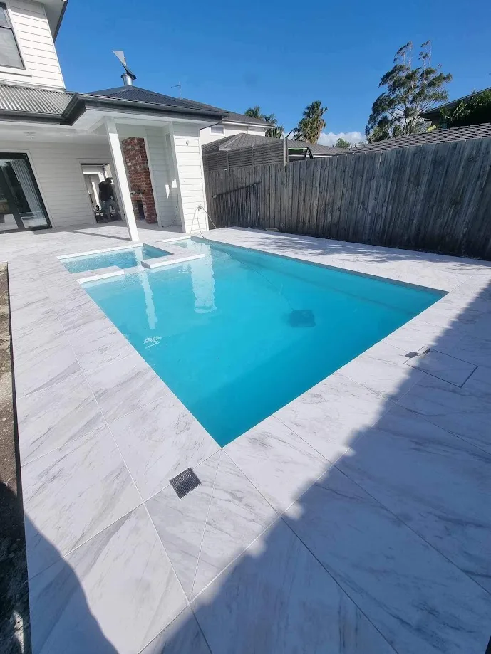 A marble look pool surround in the sun