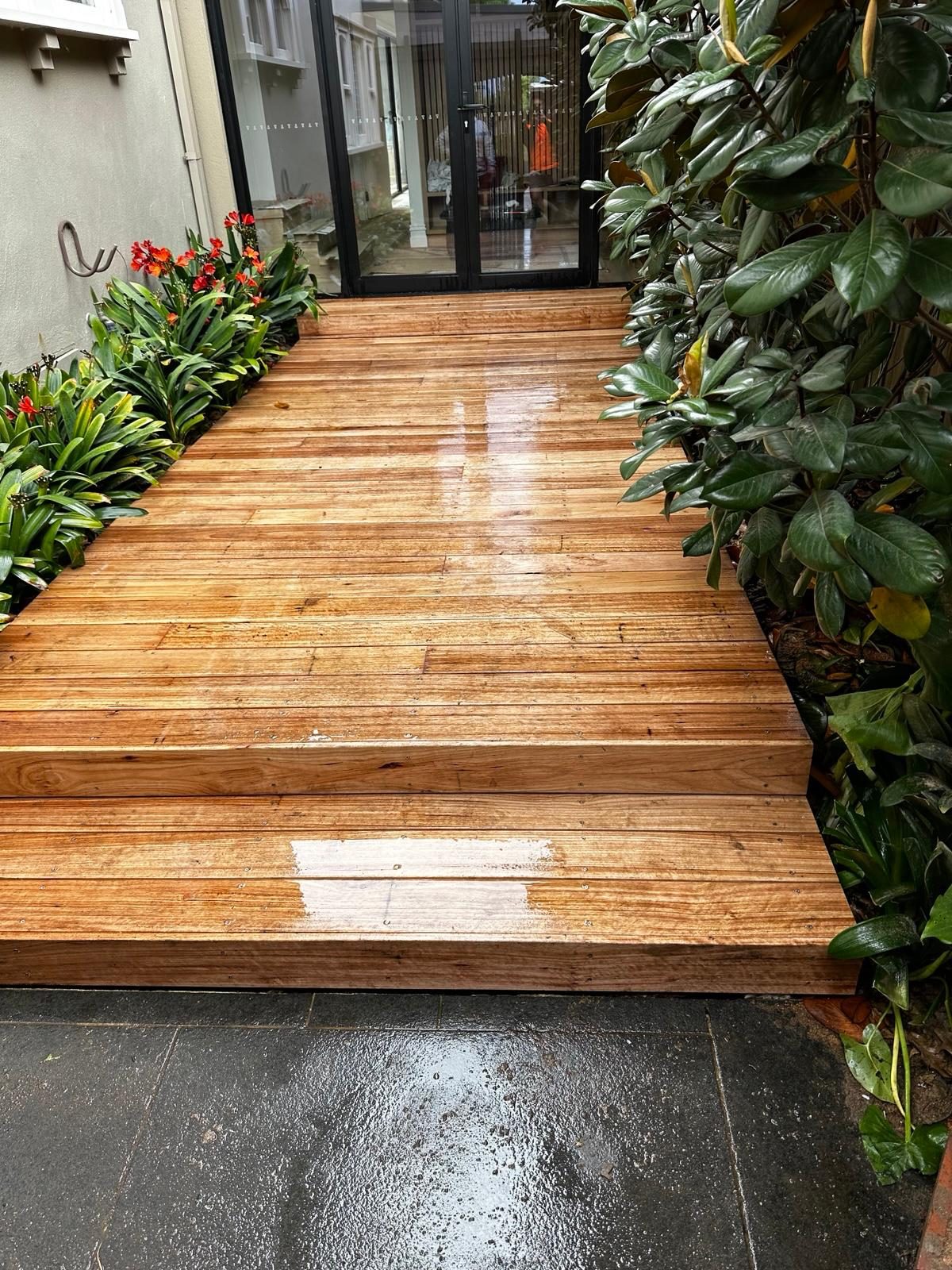 Newly laid timber deck between garden beds