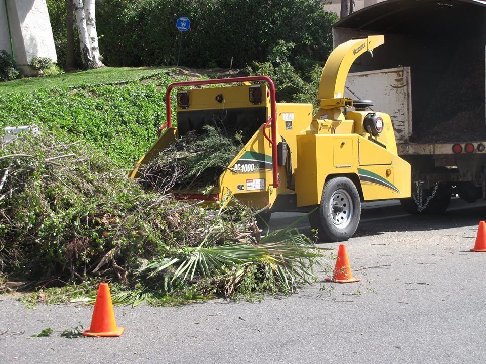 Wood chipper processing green waste at the kerb