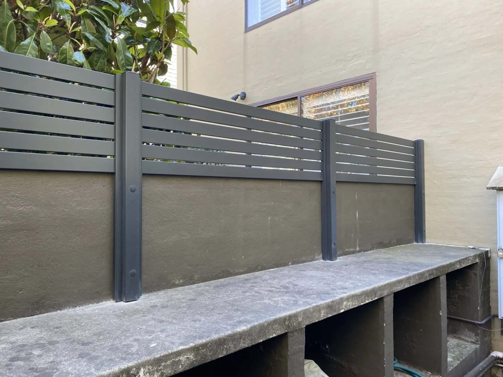Dark slat fence panels by JT Handyman in South Yarra