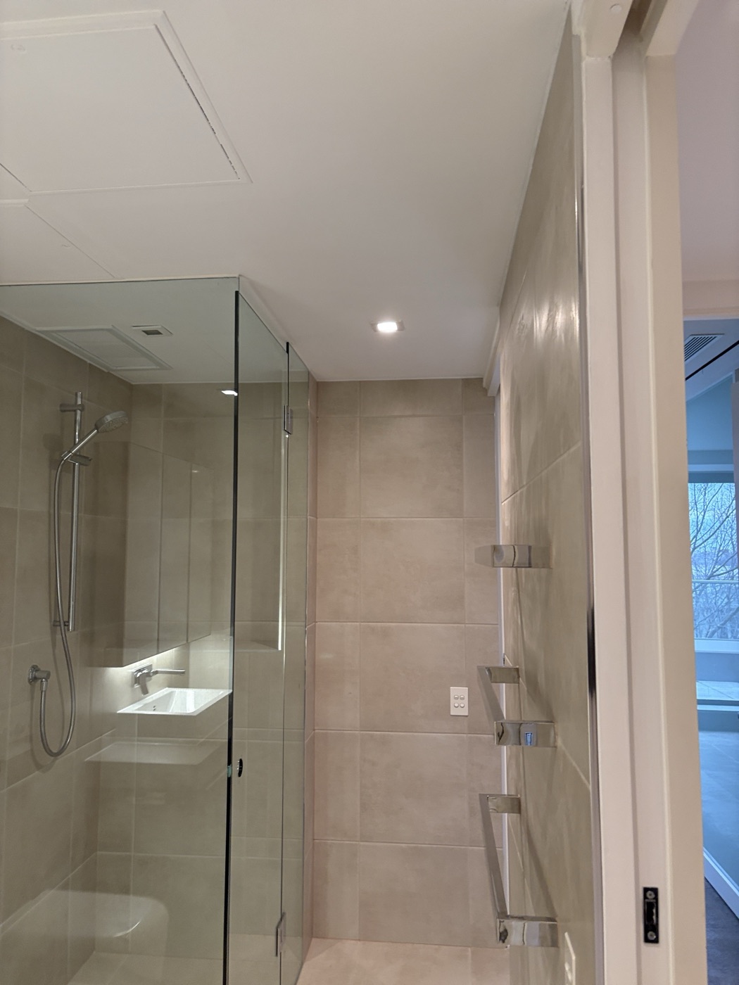Tiled shower with frameless glass screen by JT Handyman in East Melbourne