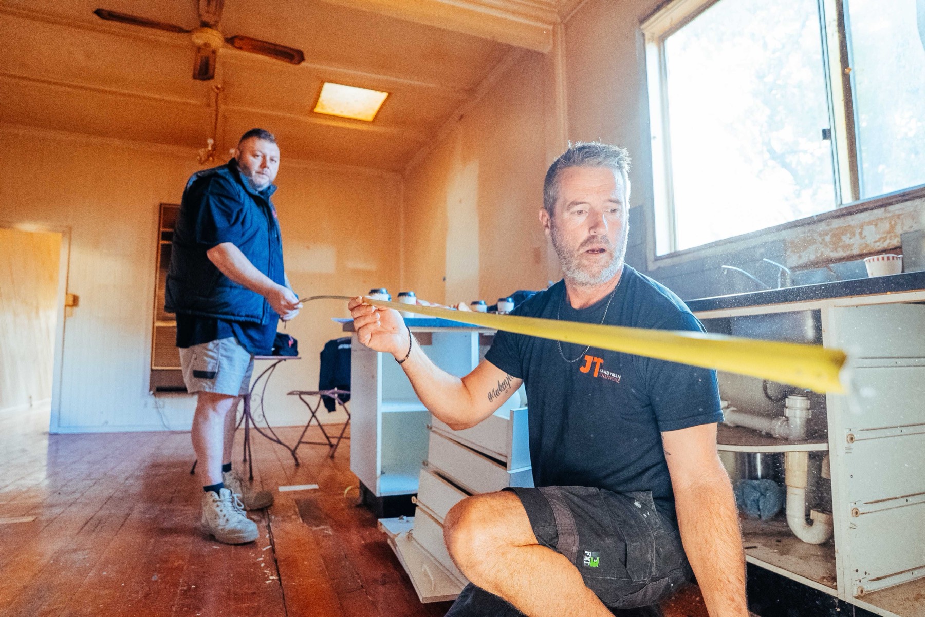JT tradesperson measuring up a job