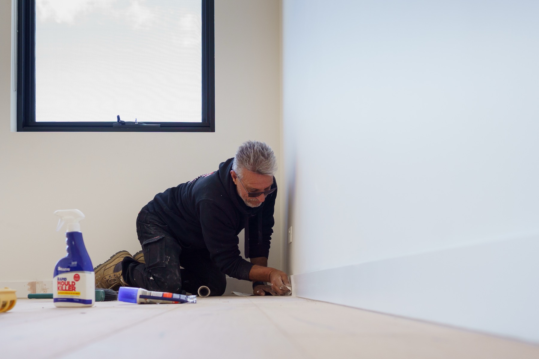 JT tradesperson plastering a wall