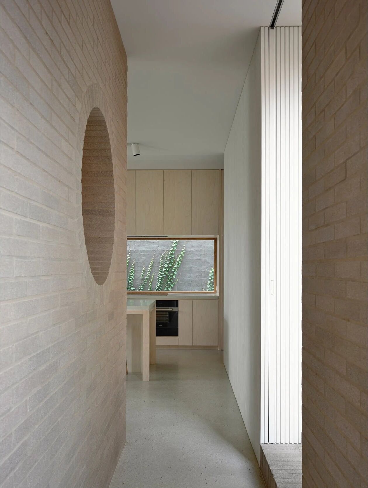 A sleek minimal hallway that recedes into light