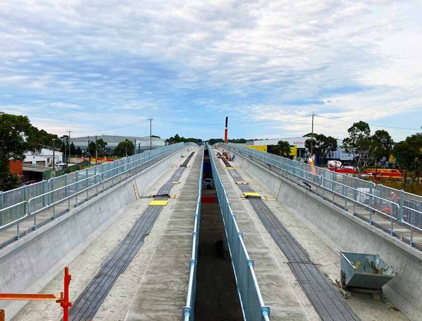 QCS finished concrete bridge deck with installed barriers