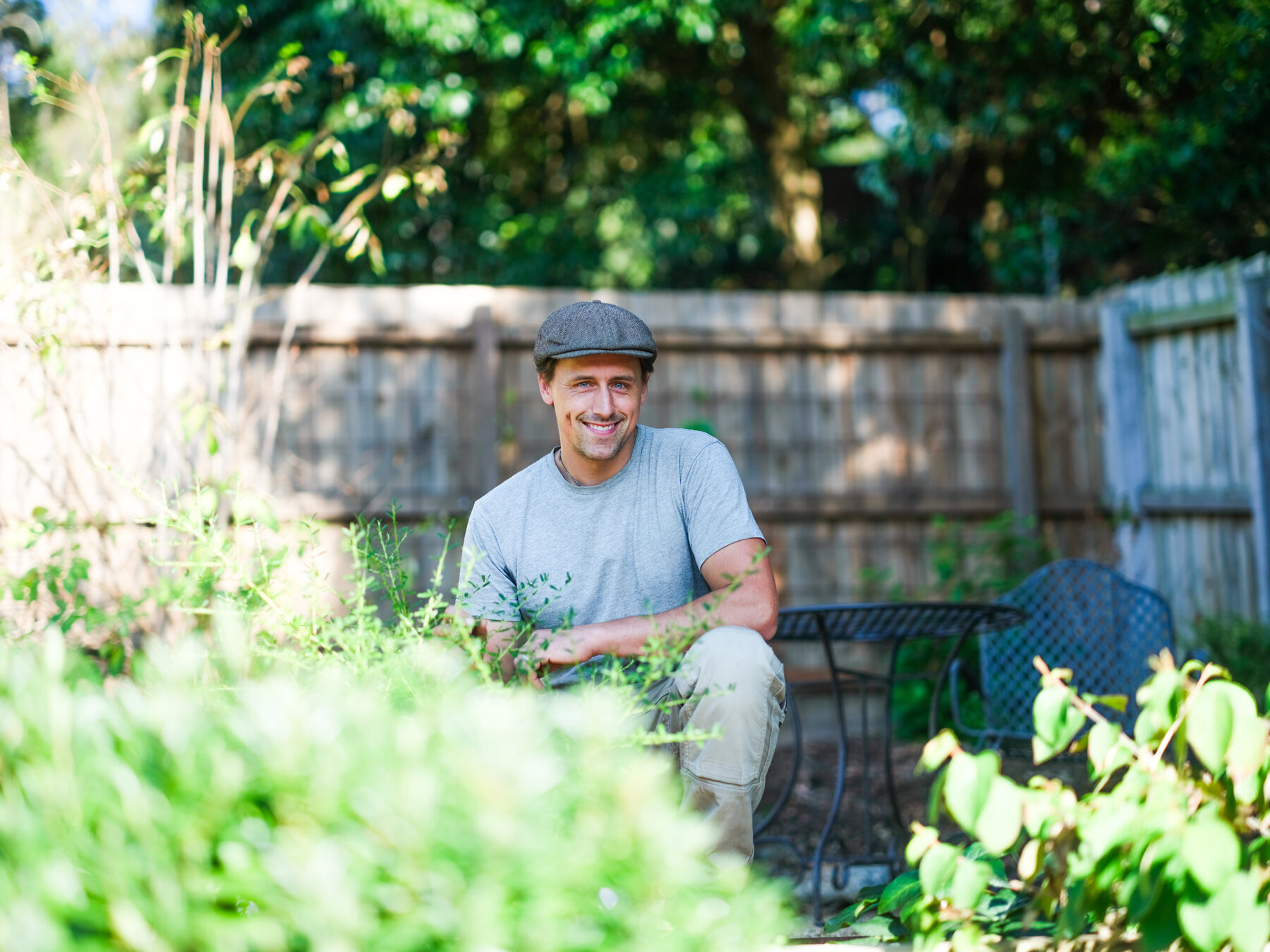 Ollie Macindoe smiling among garden planting