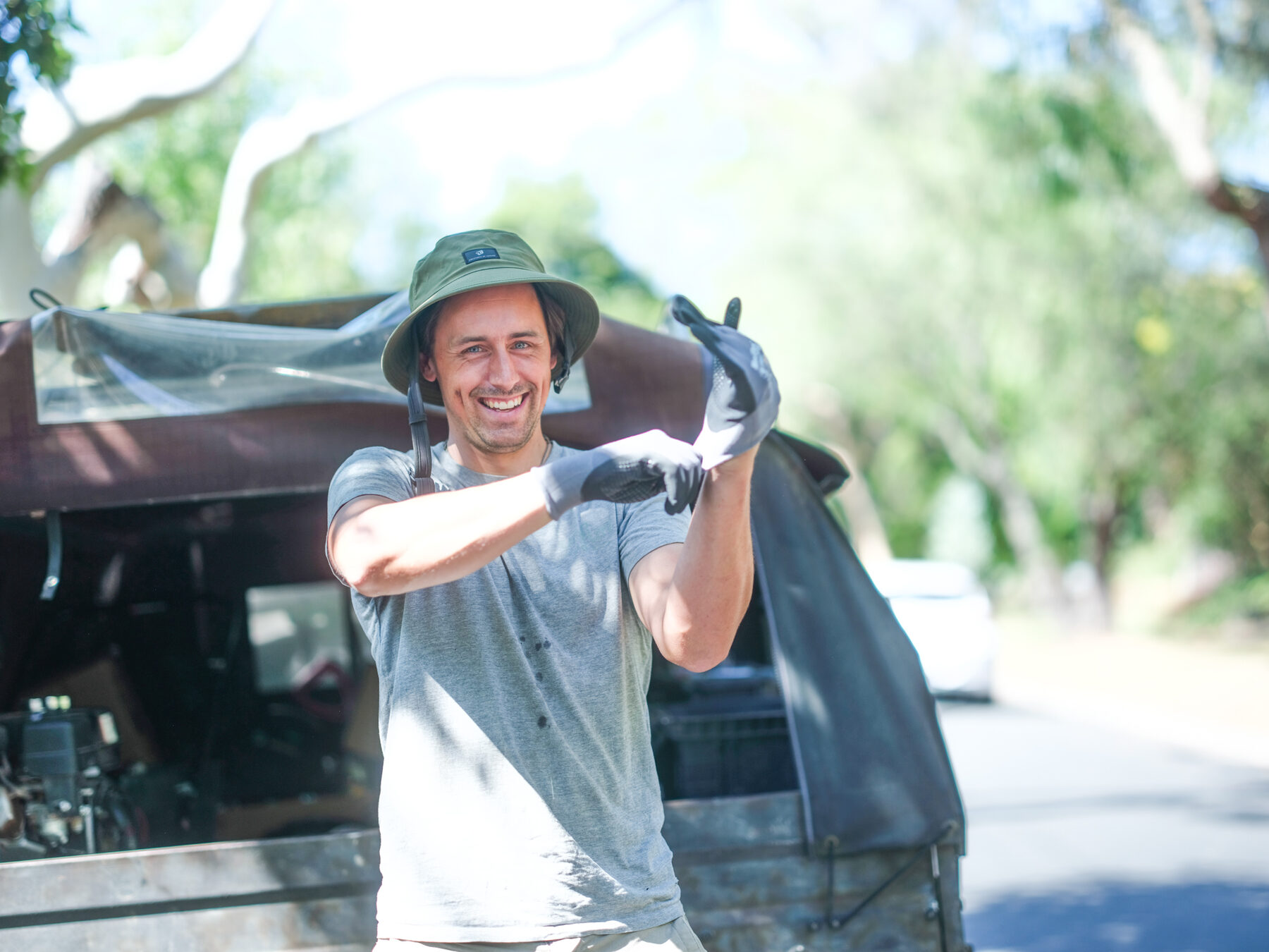 Ollie Macindoe pulling on gloves at the back of his ute