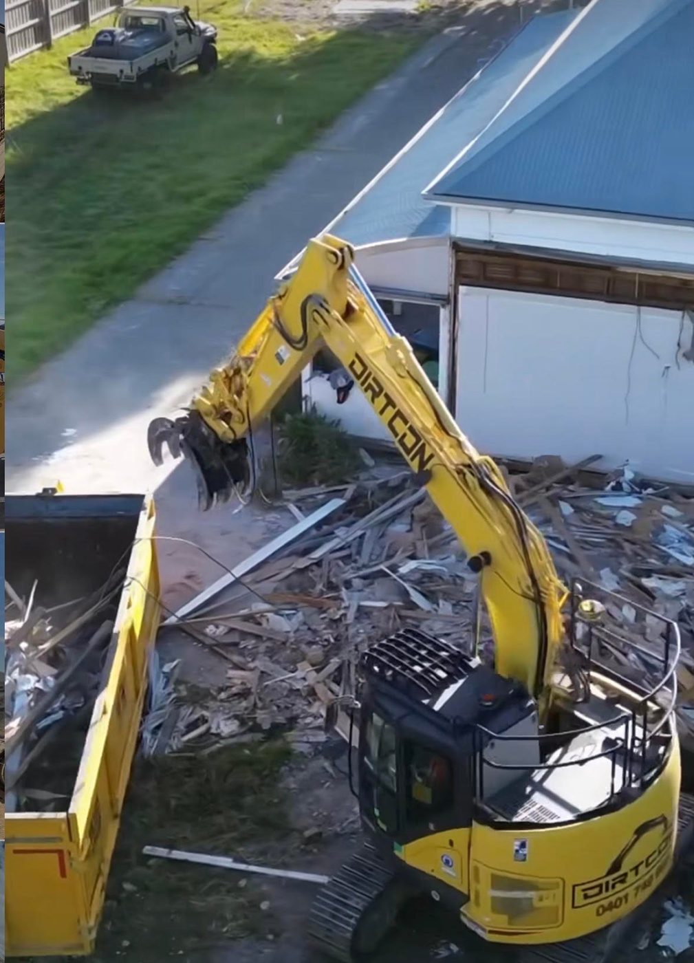 A Dirtcon excavator working through a demolition