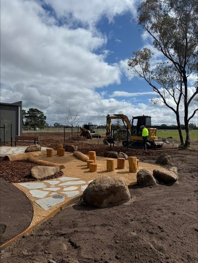 Rock placement and paving on a finished landscape site