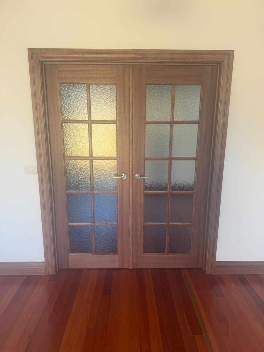 Pair of stained timber French doors with textured glass panes