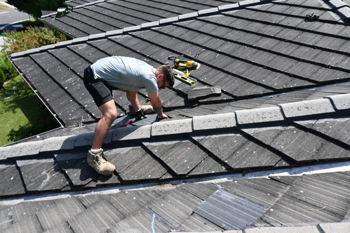A Pro Shield roofer repointing ridge capping