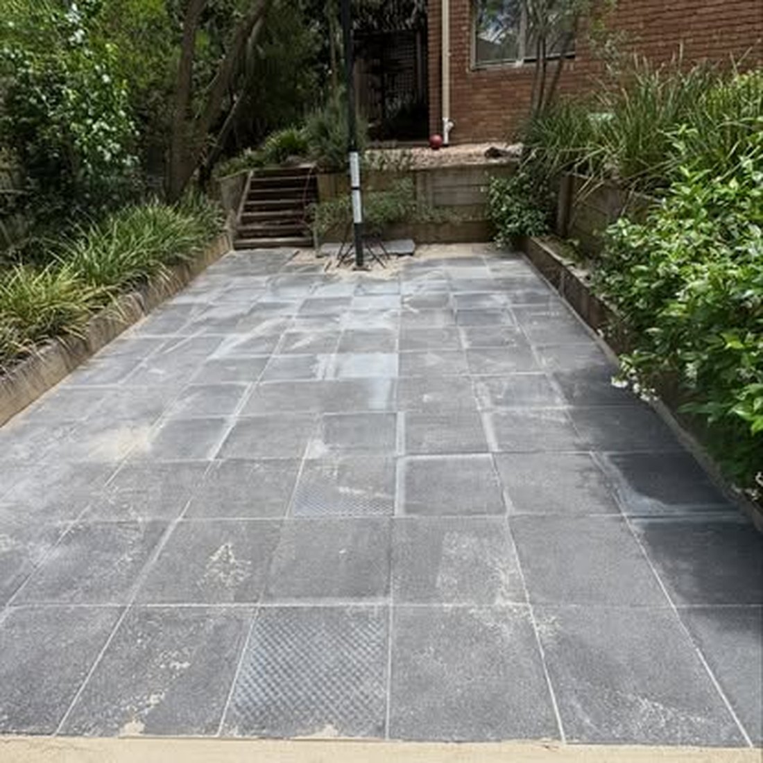 Bluestone paved path leading through a garden