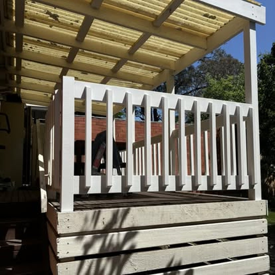 Timber pergola with a white painted balustrade