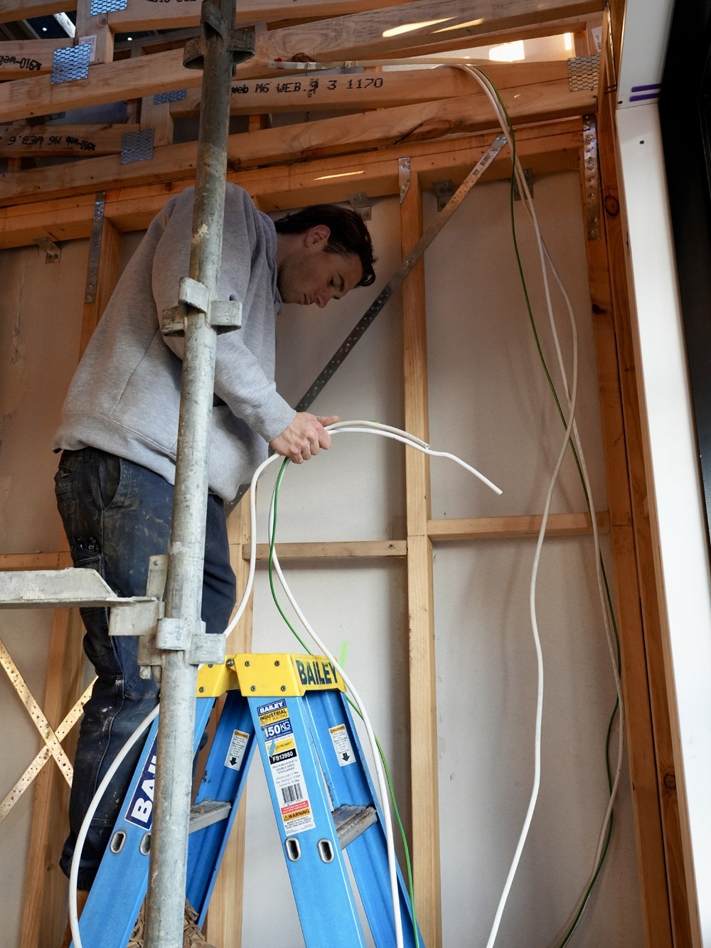 Cabling being run through a timber roof frame