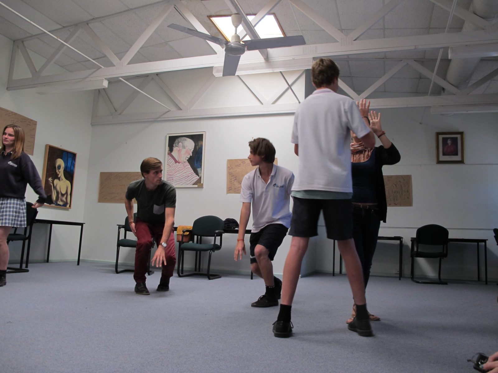 A facilitator leading a movement based leadership exercise with students
